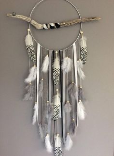 a white and black dream catcher hanging on a wall