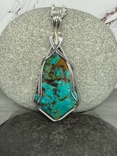 This is a beautiful piece of Kingman Ceremonial (AZ) Turquoise.   It reminds me so much of the type of Turquoise I used to wear in the '70's.   It is a very nice color of deep rich turquoise blue with a little matrix of light tan color, which I like.  It has been stabilized for strength.  I wrapped it with very minimal coverage over the face of the stone.  I used Argentium .940 Anti Tarnish Silver for the wire.  It measures approx  2.5 inches  long and 1 inch wide at the widest point. My pendant Wire Wrapped Turquoise, Turquoise Pendant Necklace, Tarnished Silver, Kingman Turquoise, December Birthstone, Light Tan, Turquoise Pendant, American Jewelry, Native American Jewelry