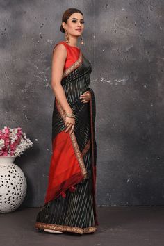 Women who wear Black live colorful lives. Designer saree in black color with gota patti work and heavy red lace border is just a cherry on the cake. The saree is light and cozy to carry and the border enlightens the look. drape yourself with elegant this black leheriya saree with gota patti work and golden lace border and add the glam to your look! DISCLAIMER:- The shown stitched blouse on the model is for display purpose only. The saree comes with a matching blouse piece and finished with fall Black Designer Saree, Golden Lace Border, Leheriya Saree, Saree In Black, Gota Patti Work, Golden Lace, Fashion Journals, Black Saree, Traditional Fabric