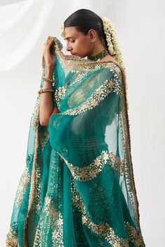 Bright shade of green lehenga with attached cancan and gota patti embroidery. Comes with gold lampi padded blouse and dupatta.
Components: 3
Pattern: Hand Embroidered
Type Of Work: Gota Patti
Neckline: Leaf
Sleeve Type: Sleeveless
Fabric: Lampi
Color: Green
Other Details: 
Floral patterns
Kiran lace hem dupatta
Attached lining
Approx. product weight (in kgs): 6
Length:
Blouse: 13 inches
Lehenga: 44 inches
Occasion: Wedding - Aza Fashions Leaf Sleeve, Green Lehenga, Padded Blouse, Lace Hem, Bridal Lehenga, Floral Patterns, Set For Women, Aza Fashion, Sleeve Type