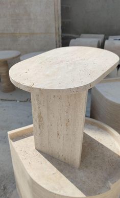 a marble table sitting on top of a cement slab