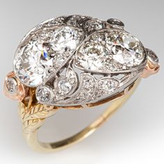 This stunning platinum topped yellow gold ring is bead set with four (4) round old European cut diamonds and accented with milgrain details. The top of the ring is bead and bezel set with a total of fourteen (14) antique round cut diamonds. The shoulders are each accented with a rose gold flower, bezel set with one (1) round single cut diamond. The ring measures 15.2mm at the top, rises 7.7mm above the finger, tapering to 1.3mm wide and 1.2mm thick at the base of the shank. It is currently a siz Luxury Fine Jewelry Diamond Ring With Bezel Setting, Antique Diamond Rings 1stdibs, Art Deco Diamond Ring, Deco Diamond Ring, Bijoux Art Nouveau, Diamond Girl, Jewellery Vintage, Diamond Cocktail Ring, Art Deco Diamond Rings