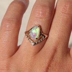 This captivating ring showcases a stunning opal, alive with flashes of green, blue, and purple hues, pristinely prong-set to capture the essence of a dream. The V-band detail is adorned with diamonds, adding a touch of celestial sparkle. opal measures 11.4mm x 7.4mm 9 1mm diamonds along the v-band Size 6.75 Can be resized up or down 2 sizes One of a kind I handcraft each one out of wax first then cast them in 14k gold. This ensures every one of a kind ring is truly unique and special in their own way. Luxury Opal Ring With Gemstone Accents, Unique Yellow Gold Opal Ring With Polished Finish, Luxury Yellow Gold Opal Ring With Gemstone Accents, Luxury Unique Opal Ring With Polished Finish, Luxury Gold Victorian Opal Ring, Opal And Sapphire Ring, Mermaid Aesthetic, Custom Ring Designs, Wedding Accessories Jewelry