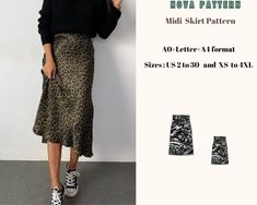 a woman standing next to a wall wearing a leopard print skirt and black sweater with her hands in her pockets