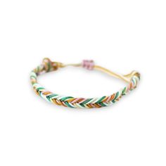 the multicolored braid bracelet with gold clasp is shown on an isolated white background