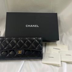 Chanel Quilted Classic Long Flap Long Wallet Black Leather Gold Coco Mark Boxed Used, In Excellent Condition Minor Scuffs On Corners Visible Scratches On Hardware Material Holds Original Shape Measurement: 7.75"L X 4"H X 1.4"W Polished Gold Hardware With Little Bit Of Fading Classic Flap With Snap Button Closure Black Quilted Lambskin Leather Maroon Fabric And Lambskin Leather Interior Lining Twelve Card Slots Two Open Compartments, Two Lining Compartments Zipper Coin Pocket Include Coa From Rea Chanel Classic Flap Bag Unboxing, Chanel Small Flap Wallet, Luxury Evening Clutch With Original Box, Elegant Bifold Wallet On Chain For Formal Occasions, Designer Clutch With Original Box For Formal Occasions, Elegant Formal Wallet With Card Slots, Elegant Formal Wallet On Chain With Card Slots, Luxury Clutch Wallet For Formal Occasions, Classic Wallet On Chain As Gift