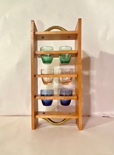 a wooden shelf with several glasses on it