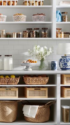 the shelves are filled with baskets and food