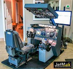 an airplane cockpit is shown with multiple controls on the front and center panel, as well as two monitors in the back