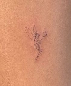 a drawing of a fairy on the back of a woman's stomach with a flower in her hair