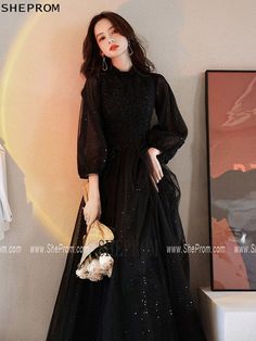 Buy Modest Black Long Tulle Formal Dress with Long Lantern Sleeves id#AM6097 at SheProm. SheProm.com is an online store with thousands of formal dresses. Shop 100% authentic prom dresses with free standard shipping. Long Black Dress With Long Sleeves, Classy Modest Dresses Formal, Long Formal Dresses With Sleeves, Flowy Long Sleeve Prom Dress, Black Dresses For Birthday, Black Prom Dress With Sleeves, Black Prom Dress Modest, Elegant Black Dress Classy Long, Long Sleeve Prom Dress Modest