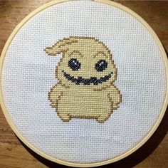 a cross stitch pattern with a smiling dog on it's face in the center