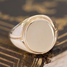 This vintage signet ring from the famed house Tiffany & Co. is big, bold, and gold - three of our favorite things here at JbyG. The 14kt gold is such a warm and buttery tone, and when worn, the ring feels like armor on the finger! The top of the ring is blank and ready to be engraved with a message or image of your choosing - or leave her blank and let your daily life leave its mark! 14kt Yellow Gold Size 9.75 & fully resizable Please see qualitative report for more information.