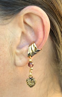 Style Tips: Wear an Ear Cuff with Charm on each ear to get a unique balanced set. Details: Weight: 1.5 gram Metal: Gold overlay on Brass Base Diameter: 0.5" Width: 0.5" Length: 1.5" Color: Gold Gold Overlay, Style Tips, Purple Gold, Heart Charm, Red Gold, One Size Fits All, Ear Cuff, With Love, Great Gifts