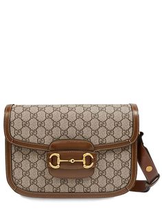 Height: 18cm Width: 25cm Depth: 8cm. Shoulder strap drop: 45cm. Adjustable shoulder strap. Flap closure. Leather details. All over logo pattern placement may vary. Gold colored metal hardware. Three internal compartments. One internal zip pocket. One internal pocket Gucci Travel Shoulder Bag With Horsebit Detail, Gucci Shoulder Bag With Horsebit Detail For Travel, Gucci Satchel Shoulder Bag With Horsebit Detail, Gucci Crossbody Bag With Horsebit Detail, Gucci Shoulder Bag With Logo Hardware, Designer Satchel Shoulder Bag With Horsebit Detail, Gucci Shoulder Bag With Detachable Strap In Monogram Canvas, Gucci Monogram Canvas Shoulder Bag With Detachable Strap, Classic Gucci Bag With Logo Hardware