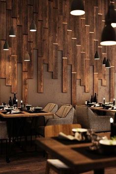 an empty restaurant with wooden walls and chairs