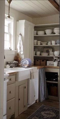 the kitchen is clean and ready to be used for cooking or baking, with dishes on the shelves