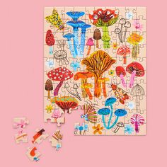 a wooden puzzle with mushrooms and flowers on it