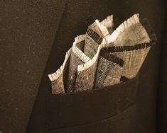 "A Gray Linen Pocket Square with White and Black Fringes. Has a salt and pepper and textured appearance due to the slubs in the thread and alternating warp and weft colors. Soft and lustrous, please dry clean only to preserve the fringed edges.  The neutral colors will match with any suit jacket or sports coat light or dark.  The above photos show the variety of ways it can be styled in your pocket to suit your preference. COLOR: Gray BORDER COLOR: White and Black SIZE: Approximately 11\" square (27 cm) MATERIAL: 100% Linen" Men Handkerchief, Wedding Hankerchief, Handkerchief Men, Sports Coat, Coat Pocket, Groom Wear, Black Fringe, Pocket Squares, Tie Set