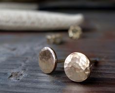 These small hammered stud earrings would make the perfect gift for your bridesmaids.  Nice and petite for a minimalist style. The Details ∞ Artisan handmade jewelry ∞ Small 14k gold filled textured discs (approx 1/4" or 6.5mm) ∞ 14k gold-filled earring backs ∞ Made to order ∞ Gift box included ∞ Made in the USA Is 14k gold-filled right for you?  If you are purchasing our gold filled stud earrings please keep in mind they are cut from a sheet of 14k gold filled metal. The front and back of the st Minimalist Hammered Earrings For Wedding, Dainty Hammered Earrings As Gift, Artisan Jewelry Handmade, Gold Filled Earrings, Simple Earrings, Handmade Artisan, Minimalist Earrings, Gold Earrings Studs, Gold Studs