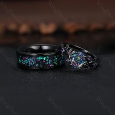 two black rings with multicolored glitters are on the table next to each other