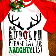 Dear Rudolph Please Eat The Naughty List Saying Across Front Of Top. A White Next Level Raglan Style With Red Sleeves. A Heat Transfer Of Rudolph Antlers With Cute Saying. Outfit Complete For The Girls A With Coordinating Bow That Is Included In Purchase. Shirt Could Be Unisex Too For Little Boys Without The Bow Of Course. Same Day Shipping If Purchases By 3pm Central. Smoke Free Home Boutique Funny Kids Christmas Shirts, Playful Cotton Christmas Top, Cute Red Holiday Tops, Cute Red T-shirt For Winter, Cute Red Winter T-shirt, Playful Red Christmas Tops, White Letter Print Shirt For Winter, Cute White Christmas T-shirt, Cute White Christmas Tops