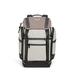 a white and black backpack with two straps on the front, one is open to show the