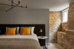 a bedroom with stone walls and a large bed