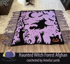 a living room filled with furniture and a purple rug on top of a wooden floor