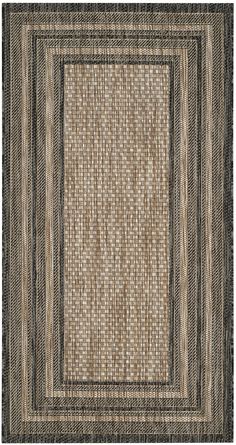 an area rug with black and tan stripes