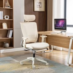 a white office chair sitting in front of a computer desk