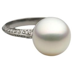 A BUNDA 'Tanara' Pearl and Diamond Ring set in Platinum, Signed BUNDA. Size M. Characteristics of White South Sea Cultured Pearl; 12mm. Characteristics of Additional Round Brilliant Cut Diamonds: 56 = .69ct, F colour, VS Clarity Weight 5.7grams Bezel Set Diamond Ring, South Sea Pearls Earrings, Diamond Ring Set, Pearl And Diamond Ring, Round Diamond Ring, Gold Cocktail Ring, Pearl And Diamond Earrings, Natural Diamond Ring, Diamonds Ring