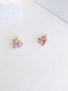 Each of these 14k gold earrings is embellished with a heart-shaped lab-created pink sapphire. Designed with friction backs, these stunning post earrings are polished to a bright shine, making them a lovely option she will want to wear often. Gold-Plated Brass Zirconia Stud Sterling Silver Posts Product Length: 11mm Product Width: 12mm Rose Gold Heart Cut Earrings, Pink Fine Jewelry Heart Earrings As Gift, Pink Heart Earrings Fine Jewelry For Gifts, Elegant Pink Cubic Zirconia Heart Earrings, Pink Round Heart Earrings, Pink Heart Cut Wedding Earrings, Elegant Pink Heart Earrings For Anniversary, Elegant Pink Heart Cut Earrings, Pink Earrings For Anniversary