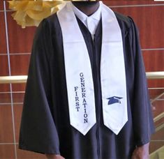 a black and white graduation gown hanging on a wall