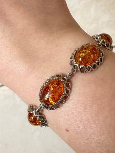 VINTAGE AMBER STERLING SILVER  BRACELET ♥ ♡ ♥ ♡ ♥ ♡ ♥ ITEM DESCRIPTION:  Good condition! Slight surface scratches  ‣ Width: 15mm  ‣ Height: 6.5mm ‣ Weight: 17.2 grams   ‣ Length: 7 inches + 1 inch extension ‣ Material: Sterling Silver, Amber  ‣ 925 stamp on the back   ‣ If you would like any additional details on the above item, we would be happy to help!!   ‣ All vintage items are professionally cleaned ♥ ♡ ♥ ♡ ♥ ♡ ♥ SHIPPING INFORMATION: ‣ Item comes with free tracked regular shipping within Canada ‣ If you do wish to have a faster shipping option please let us know!  ♥ ♡ ♥ ♡ ♥ ♡ ♥ Amber Bracelet, Bracelet Vintage, Amber Jewelry, Sterling Silver Bracelet, Jewelry Vintage, Chain Link Bracelet, Sterling Silber, Vintage Sterling Silver, Sterling Silver Bracelets