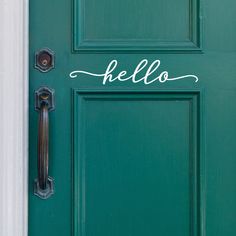 a green door with the word hello painted on it