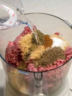 a food processor filled with meat and spices