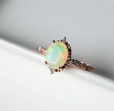 Ethiopian opal engagement ring in solid rose gold, set with a total of 0.1ct diamonds. ♥ Material: Solid 14k/18K gold or platinum; Natural Ethiopian Opal; ♥ Dimension: Band measures about 1.5mm wide; 6mm *8mm oval Opal; ♥ The Ethiopian opal displays a variety of different colours Vintage Opal Gemstone Ring For Wedding, Vintage Opal Ring For Wedding, Vintage Style Opal Wedding Ring, Vintage White Opal Ring For Wedding, Vintage White Opal Wedding Ring, Vintage Diamond Opal Ring For Anniversary, Vintage White Gold Opal Ring For Wedding, White Gold Vintage Opal Ring For Wedding, Vintage White Gold Opal Wedding Ring