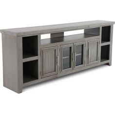 an entertainment center with two doors and three shelves on each side, in grey wood