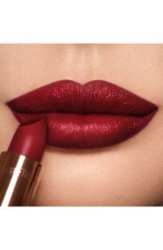 Find CHARLOTTE TILBURY Ki.s.s.i.n.g. Lipstick on Editorialist. What it is: A signature range of lipsticks curated with modern and classic icons in mind.What it does: K.I.S.S.I.N.G. offers a capsule color wardrobe, with colors ranging from backstage nudes to red-carpet reds, made to suit any skin tone. The lipsticks are enriched with the antioxidant Lipstick Tree, a breakthrough secret ingredient that naturally protects lips from UV damage, leaving them cashmere-soft and irresistible. The lipsticks are also blended with special waxes and clever light-diffusing pigments to bring you full-bodied, ultra-brilliant lips. How to use: You can get multiple looks from your lipstick using multiple techniques. For the day, always use a matching lip liner for naturally defined lips. Apply the lipstick James Bond Makeup, Charlotte Tilbury Lipstick Swatches, Ulta Wishlist, Bridal Makeup Red Lips, Perfect Lipstick Shade, Color Wardrobe, Wedding Lips, Best Lipstick Color, Lipstick For Dark Skin