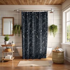 a bath room with a toilet and a shower curtain in it's center area