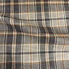 a plaid fabric is shown in grey, brown and white colors on a black background