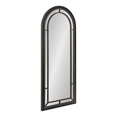 a mirror that is on the wall next to a white background with an arched window