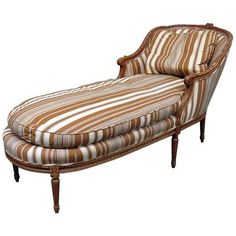 an old fashioned chaise lounge with striped fabric