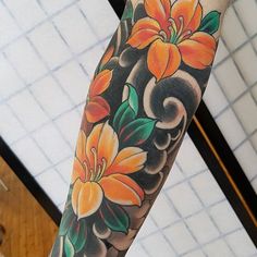 the arm is decorated with flowers and leaves