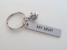 a metal keychain with a basketball on it that says, my mmp