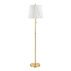 a gold floor lamp with a white shade