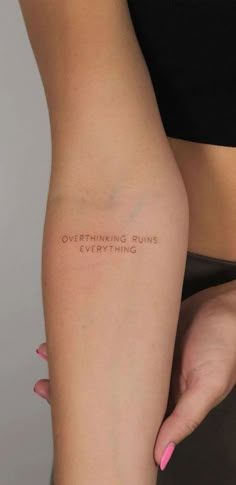 a woman's arm with the words overthiring runs everything written on it