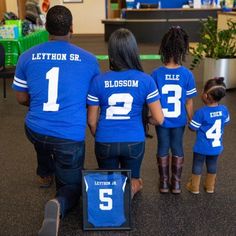 a group of people in blue shirts standing next to each other