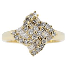 Own a piece of timeless elegance with this stunning 18k yellow gold ring. This captivating piece features a mesmerizing display of 48 sparkling diamonds, boasting a total carat weight of 0.42ct. The centerpiece is a cluster of 28 round brilliant diamonds, meticulously cut to radiate brilliance with a total carat weight: of 0.28ct. These dazzling stones are complemented by 20 elegant taper diamonds with a total carat weight: of 0.14ct. Both the round and taper diamonds are graded H for color and SI for clarity, offering a brilliant sparkle. Crafted from luxurious 18k yellow gold, the ring offers a comfortable weight of 4.47 grams and a size of 5 5/16. This exquisite piece will surely become a treasured heirloom, adding a touch of sophistication to any outfit. Metal: 18k Yellow Gold Main sto 18k Yellow Gold Ring, Diamond Cluster Ring, Yellow Gold Ring, Diamond Cluster, Sparkle Diamonds, Cluster Ring, Yellow Gold Rings, Round Brilliant, Gold Ring